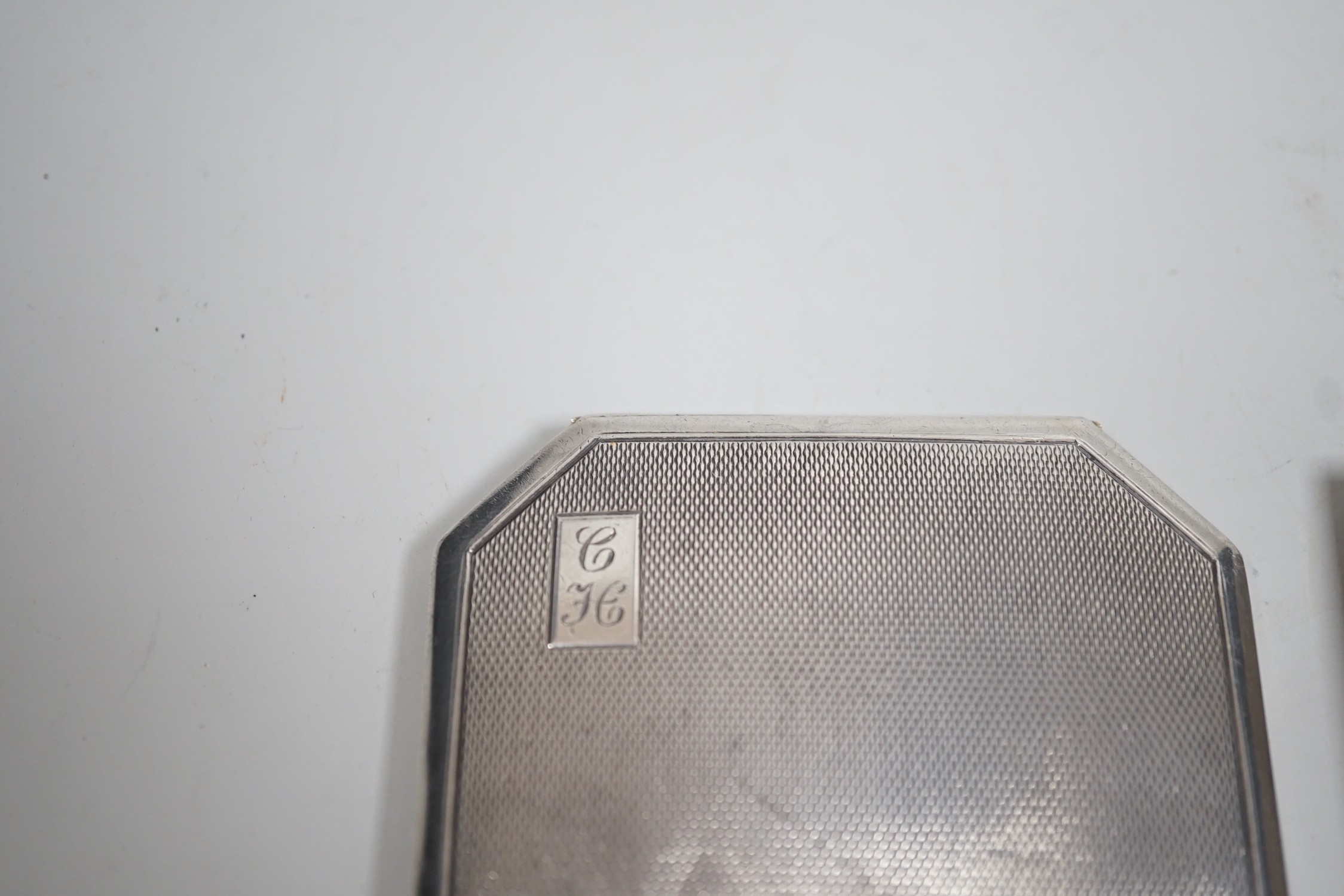 A George V Art Deco silver cigarette case, David Sutton & Sons, London, 1935, 65mm, with leather carrying case, together with three engine turned silver compacts.